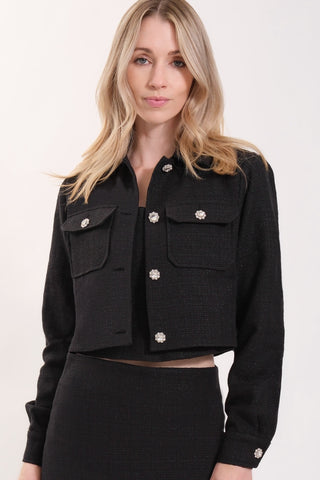 The model is wearing a black noir Vivienne Tweed Jacket by Chloe Colette.