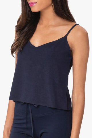 Model is wearing a navy Cassi vneck cami by Chloe Coleette.