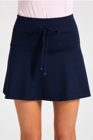 Model wearing a navy Sarah mini skirt by Chloe Colette