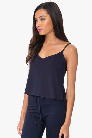 Model is wearing a navy Cassi vneck cami by Chloe Colette.