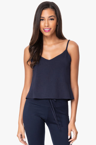 Model is wearing a navy Cassi v neck cami by Chloe Colette.