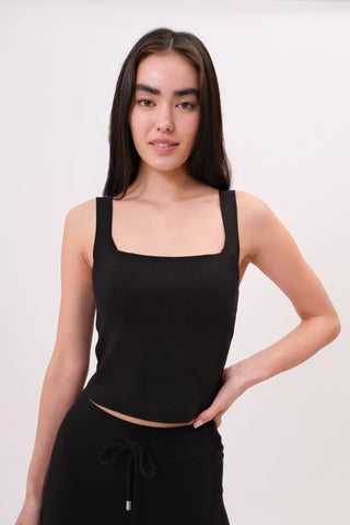 The model is wearing a black Anjelika Square Neck Top by Chloe Colette showing the front side.