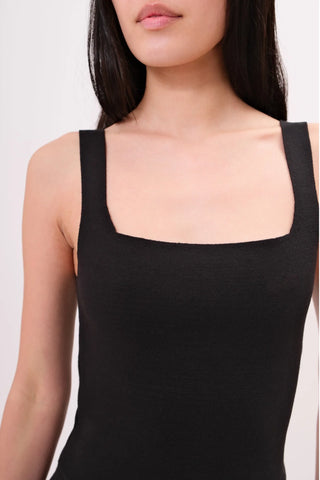 The model is wearing a black Anjelika Square Neck Top by Chloe Colette showing the front side.