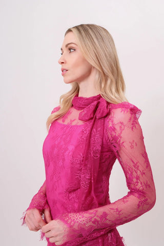 The model is wearing a hibiscus Madonna Lace Top by Chloe Colette.