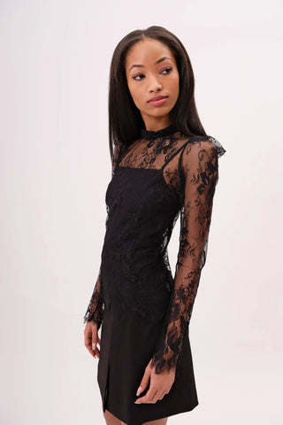 The model is wearing a black noir Madonna Lace Top and Jenny Mini Skirt by Chloe Colette.