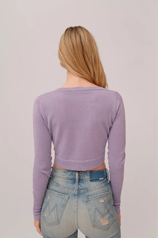 The model is wearing a amethyst Glitz Cardi top by Chloe Colette showing the back side.