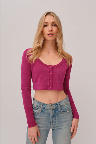 The model is wearing a fuchsia Glitz top by Chloe Colette showing the front side.