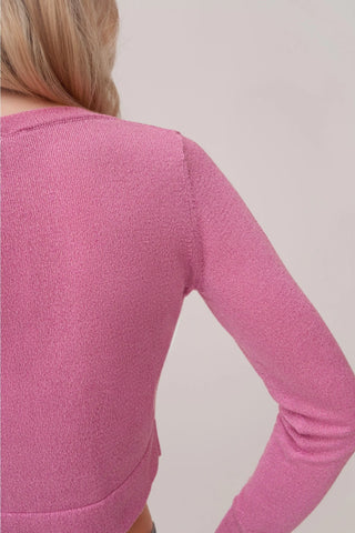 The model is wearing a rose quartz Glitz Cardi top by Chloe Colette showing close up of the back side.
