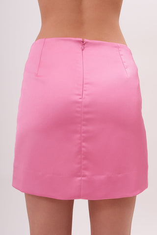 The model is wearing a satin pink pearl Jenny Mini Skirt by Chloe Colette showing the back side close up.