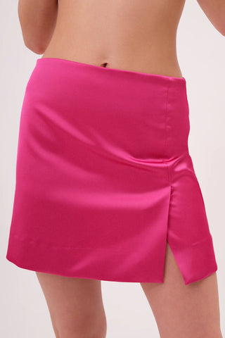 The model is wearing a satin roselite Jenny Mini Skirt by Chloe Colette showing the front side.