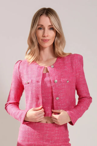 The model is wearing a Juliette tweed jacket and Jenny Tweed Mini Skirt in fuchsia color by Chloe Colette.