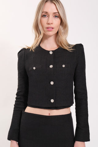 The model is wearing a black Juliette Tweed Jacket and Jenny Tweed Mini Skirt by Chloe Colette.