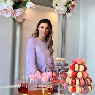 Model in front of cookies with a lavender top.