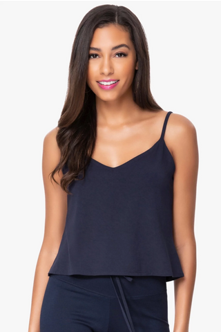 Model is wearing a navy Cassi v neck cami by Chloe Colette.