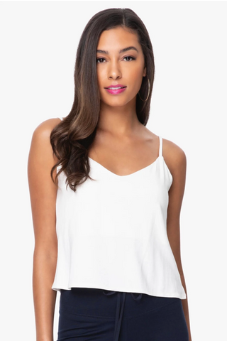 Model is wearing a white Cassi vneck cami by Chloe Colette.