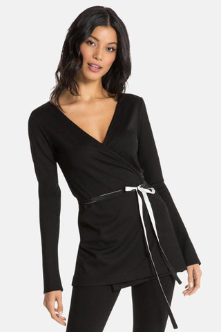 Model is wearing a black Clair Wrap Tunic by Chloe Colette.