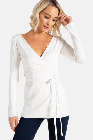 Model is wearing a ivory Clair Wrap Tunic by Chloe Colette.