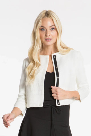 Model is wearing a ivory coco classic women's jacket by Chloe Colette.