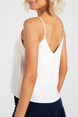 Model wearing a white silk strappy cami v-neck Jennifer by Chloe Colette.