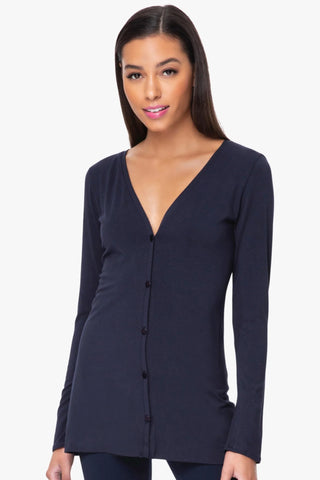 Model is wearing a navy Melissa tunic cardigan by Chloe Colette.