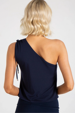Model is wearing a blue Julie on shoulder top by Chloe Colette.