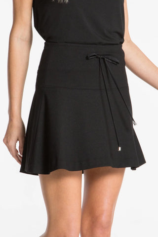 Model is wearing a black Sarah mini skirt by Chloe Colette.