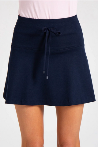 Model is wearing a navy Sarah mini skirt by Chloe Colette