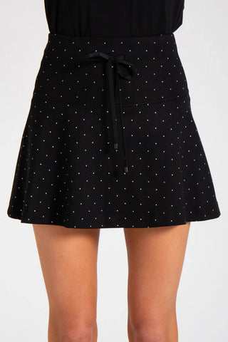 Model is wearing a pindot Sarah mini skirt by Chloe Colette.