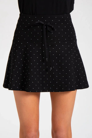 Model is wearing a pindot Sarah mini skirt by Chloe Colette
