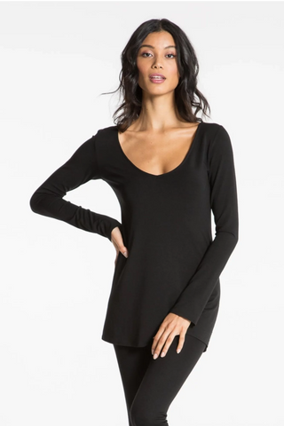 Model is wearing a black Sonja long sleeve tunic tee by Chloe Colette.