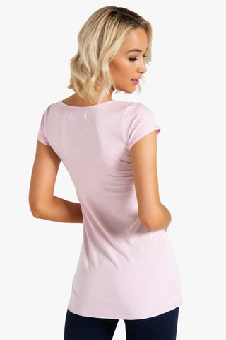 Model is wearing a ballet pink short sleeve tunic Virginia by Chloe Colette.