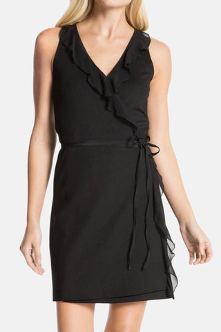 Model is wearing a black Bliss wrap mini dress by Chloe Colette.