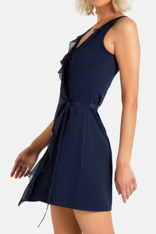 Model is wearing a navy Bliss wrap mini dress by Chloe Colette.