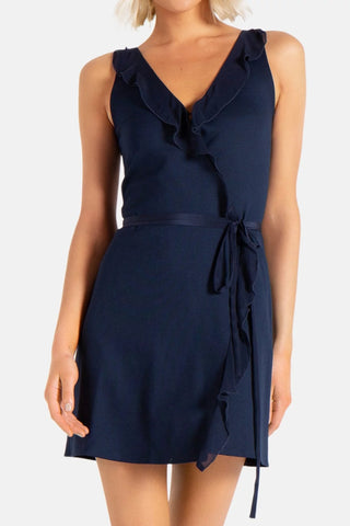 Model is wearing a navy Bliss wrap mini dress by Chloe Colette.